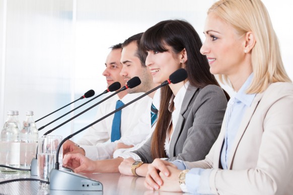 Business People Speaking In Microphone